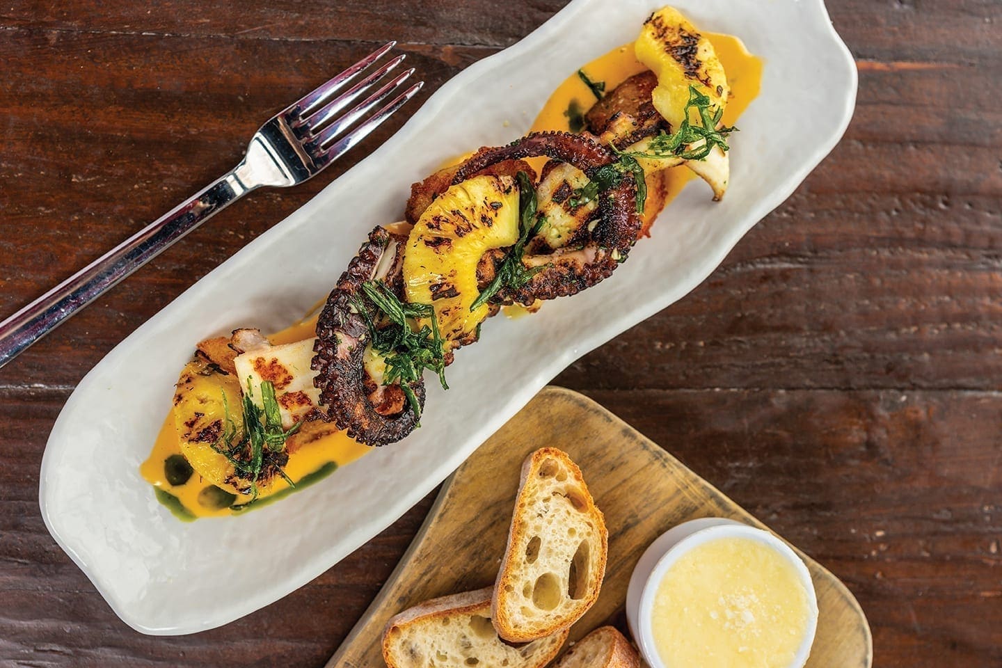 Battello signature dishes Grilled Octopus with crispy potatoes, Ricotta Gnocchi, Seafood Tower Schooner.